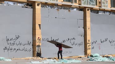 A man carries a board following Tuesday's blast in Beirut's port area, Lebanon August 8, 2020. (Reuters)