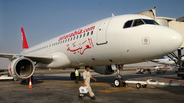 A worker walks past an Air Arabia plane. (File photo: Reuters)