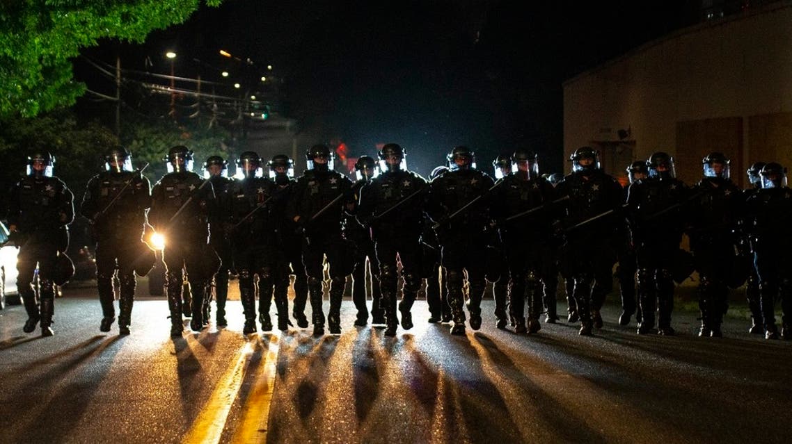 Portland police officers walk through a neighborhood after dispersing a protest of about 200 people from in front of a county Sheriff's Office, Aug. 8, 2020 in Portland. (File Photo: AP)