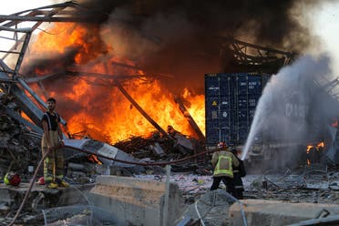 Firefighters douse a blaze at the scene of an explosion at the port of Lebanon's capital Beirut on August 4, 2020. (AFP)