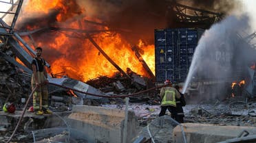Firefighters douse a blaze at the scene of an explosion at the port of Lebanon's capital Beirut on August 4, 2020. (AFP)