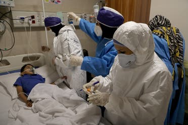 Nurses take a sample from Parham, a 7-year-old, to test for the coronavirus disease (COVID-19), at a hospital, in Tehran, Iran, July 8, 2020. (Reuters)