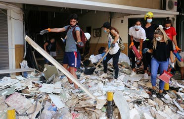 Volunteers clean rubble from the streets following Tuesday's blast in Beirut's port area. (Reuters)