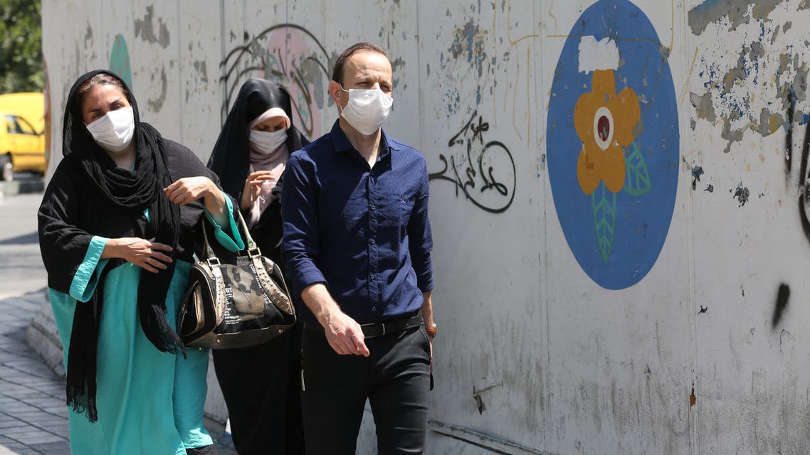Iranians wearing face masks walk down a street in the capital Tehran amid the novel coronavirus pandemic on August 9, 2020.