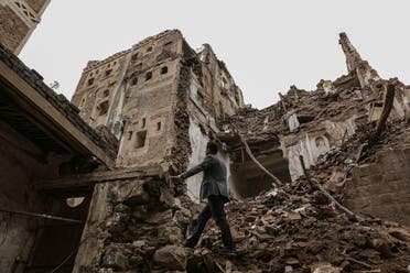 A man walks past a building collapsed by rain in the UNESCO World Heritage site of the old city of Sanaa. (Reuters)20. (Reuters)