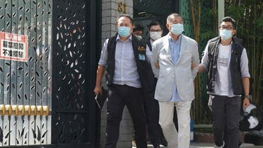 Hong Kong media tycoon Jimmy Lai, center, who founded local newspaper Apple Daily, is arrested by police officers at his home in Hong Kong, Monday, Aug. 10, 2020. (AP)