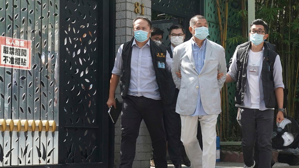 Hong Kong media tycoon Jimmy Lai, center, who founded local newspaper Apple Daily, is arrested by police officers at his home in Hong Kong, Monday, Aug. 10, 2020. (AP)
