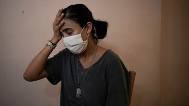 Rachelle Boumelhem reacts during an interview in her damaged beauty salon in Beirut on Aug. 10, 2020. (AP)