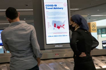 A sign alerts travelers to the danger of COVID-19 at LaGuardia Airport, during the outbreak of the coronavirus disease (COVID-19), in New York. (Reuters)