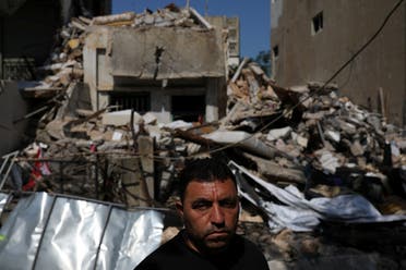 Ahmed Staifi poses for a picture in front of the house were his wife and two of his daughters were killed. (Reuters)