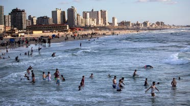 Palestinians enjoy swimming on the beach during a sunny day in Gaza City on May 29, 2020. (AP)