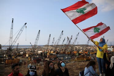 A demonstrator waves the Lebanese flag during protests near the site of the blast at the Beirut's port area on August 11, 2020. (Reuters)