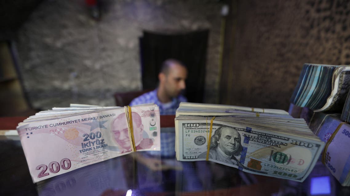 Banknotes of U.S. dollars and Turkish lira are seen in a currency exchange shop in the city of Azaz, Syria August 18, 2018. Picture taken August 18, 2018. REUTERS/Khalil Ashawi