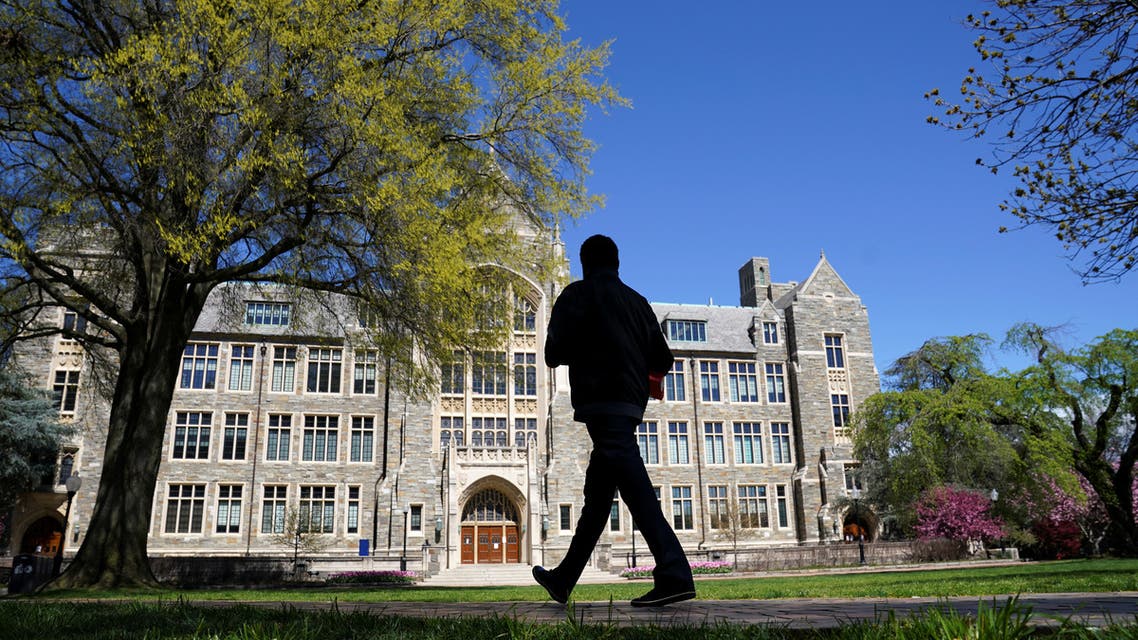 A man walks at an empty campus green at Georgetown University, closed weeks ago due to coronavirus, in Washington on April 3, 2020. (Reuters)