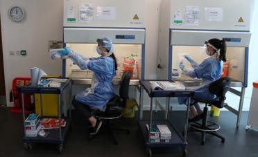 Technicians work at the new COVID-19 testing lab at Queen Elizabeth University Hospital in Glasgow, Britain on April 22, 2020. (Reuters)