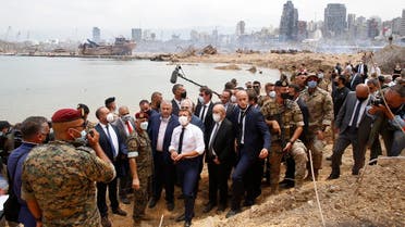 French President Emmanuel Macron and his Foreign Affairs Minister Jean-Yves Le Drian visit the site of the explosion at the Port of Beirut, Aug. 6, 2020. (AFP)