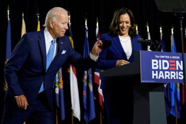 Democratic presidential candidate Joe Biden gets his face mask from the podium before his running mate Kamala Harris speaks during a campaign event, Aug. 12, 2020. (AP)
