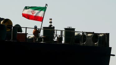 A crew member raises the Iranian flag on Iranian oil tanker Adrian Darya 1, previously named Grace 1, in the Strait of Gibraltar, Spain, Aug. 18, 2019. (Reuters)