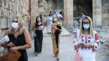 People wearing protective face masks enter the ancient amphitheater of Epidaurus in Epidaurus, Greece, July 24, 2020. (Reuters)