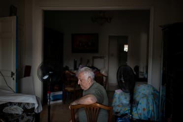 Tony Matar, 68, sits on a chair in his living room at his home that was damaged by an explosion at the Beirut port, in the neighbourhood of Karantina, Beirut. (Reuters)
