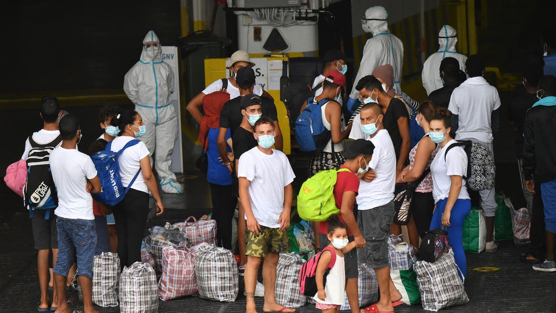 Migrants board the 'MS GNV Azzurra' quarantine ship which has has been sent on the Italian Pelagie Island of Lampedusa on August 4, 2020, amid the COVID-19 (novel coronavirus) pandemic. The interior ministry has acknowledged that the economic crisis caused by COVID-19 in Tunisia has fed an exceptional flow of economic migrants to Italy's borders, while the virus has made managing numerous daily arrivals more complex.