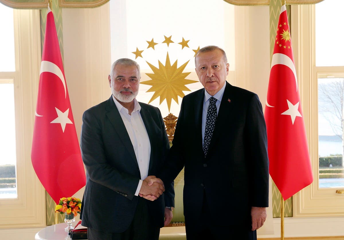 Turkey's President Recep Tayyip Erdogan, right, shakes hands with Hamas movement chief Ismail Haniyeh, prior to their meeting in Istanbul. (AP)