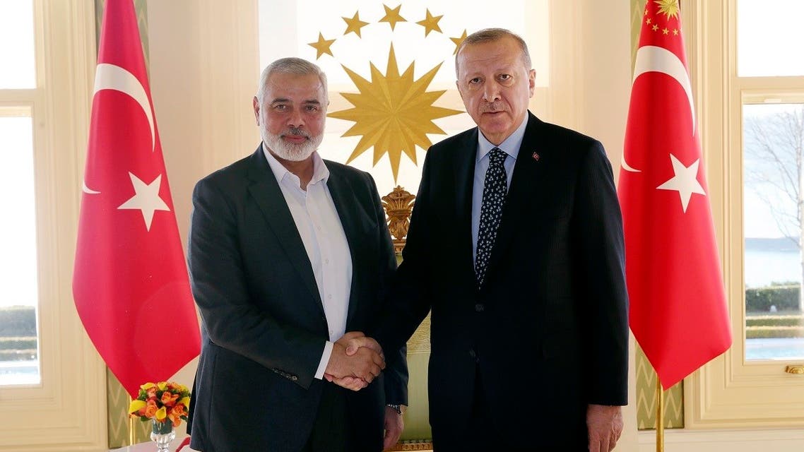 Turkey's President Recep Tayyip Erdogan, right, shakes hands with Hamas movement chief Ismail Haniyeh, prior to their meeting in Istanbul. (AP)