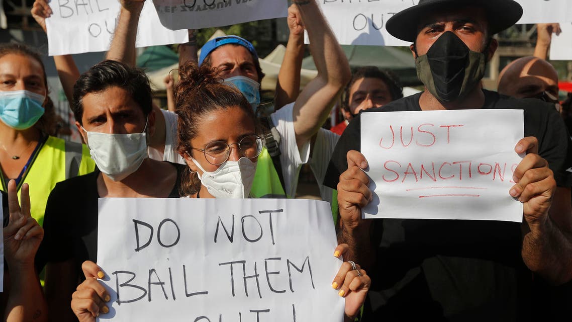 Activists in Beirut hold up placards against Lebanese politicians on Aug. 13, 2020. (AP)
