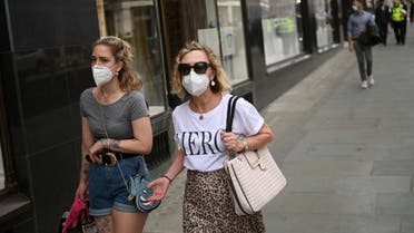 Shoppers wear face masks in central London on July 24, 2020, as lockdown restrictions continue to be eased during the novel coronavirus COVID-19 pandemic. (AFP)