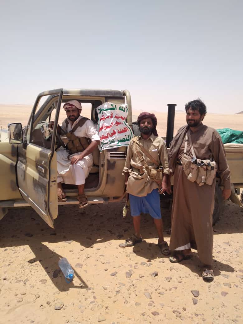 Yemeni army soldiers pictured after a battle against militants and confiscating a Houthi vehicle with the group’s slogan still shown on the car. (Supplied)