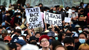 Anti-government protesters hold up signs during a rally at Democracy Monument in Bangkok on August 16, 2020. (AFP)