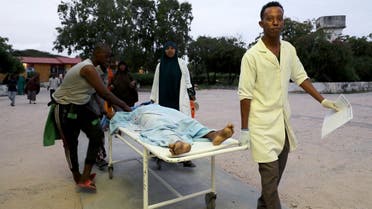 Paramedics and civilians carry an injured person on a stretcher at Madina hospital after a blast at the Elite Hotel in Lido beach in Mogadishu, Somalia August 16, 2020. (Reuters)