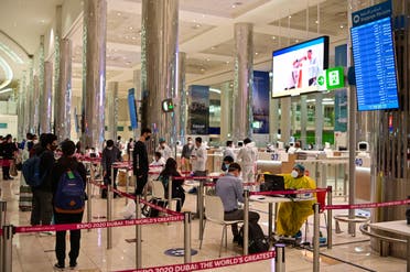 Tourists get a medical screening upon arrival at Teminal 3 at Dubai airport, in the United Arab Emirates, on July 8, 2020. (AFP)
