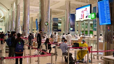 Tourists get a medical screening upon arrival at Teminal 3 at Dubai airport, in the United Arab Emirates, on July 8, 2020. (AFP)
