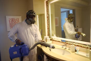 A worker wearing a protective suit sterilizes a bathroom in the Atlantis The Palm hotel in Dubai, United Arab Emirates July 7, 2020. (Reuters)