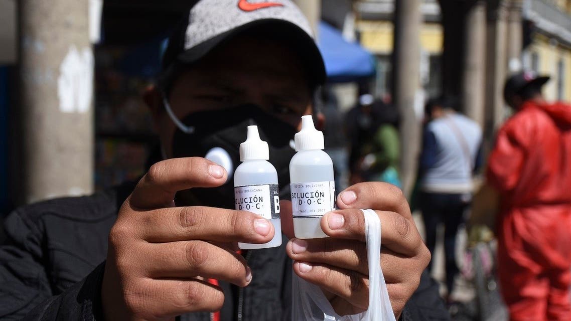 A man shows bottles of chlorine dioxide he purchased at a pharmacy in Cochabamba, Bolivia. (AP)