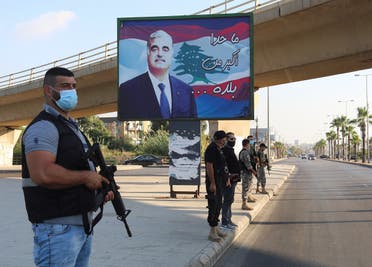 Members of security forces stand guard near a billboard depicting Lebanon's former Prime Minister Rafik al-Hariri, who was killed in a 2005 suicide bombing, in Sidon, southern Lebanon. (File photo: Reuters)