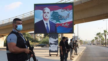 Members of security forces stand guard near a billboard depicting Lebanon's former Prime Minister Rafik al-Hariri, who was killed in a 2005 suicide bombing, in Sidon, southern Lebanon. (Reuters)