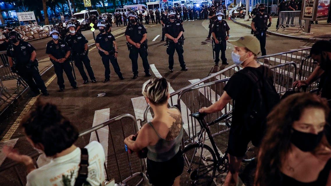 Demonstrators stand at a police barricade as New York City police officers near a protest march in support of the Black Lives Matter movement and other groups, July 30, 2020, in New York. (AP)