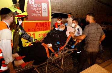 A Palestinian woman is carried in a stretcher by Israeli medics in Old City of Jerusalem following a reported stabbing attack, August 17, 2020. (AFP)