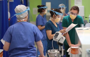In this photo taken on Monday, May 4, 2020, medical staff wearing face masks and shields to protect against coronaviurs, work in the respiratory emergency department at Craigavon Area Hospital in Co Armagh, Northern Ireland. (AP)