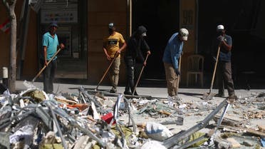 People clean debris from the street following Tuesday's blast in Beirut's port area, Lebanon August 9, 2020. (Reuters)