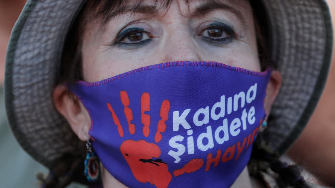 A demonstrator wearing a protective face masks with a sign reading: No to violence against women, takes part in a protest against femicide and domestic violence, amid the coronavirus disease (COVID-19) outbreak, in Istanbul, Turkey August 5, 2020. (Reuters)