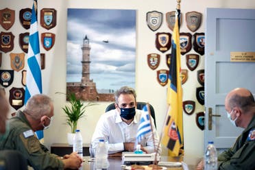 In this photo provided by the Greek Prime Minister's Office, Greece's Prime Minister Kyriakos Mitsotakis, attends a meeting with officers during his visit at the Air Force base in Souda, on the southern island of Crete, Greece on Aug. 15, 2020. (AP)