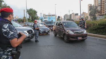 Members of the Lebanese security forces man a checkpoint on an avenue in the capital Beirut to verify the compliance with restrictions on the first day of a reinstated lockdown to combat a surge in COVID-19 cases, on August 21, 2020. (AFP)