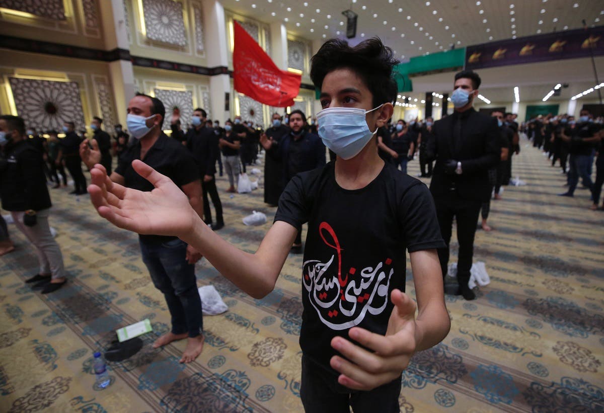 An Iraqi youth beats his chest in a mourning ritual as Shiite Muslim men mark Ashura commemorations at the headquarters of Shiite Muslim leader and head of Hikma party Ammar al-Hakim, in the capital Baghdad, on August 21, 2020. (AFP)