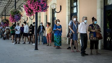  People queue at a coronavirus free screening operation outside the Arcachon railway station, southwestern France, on July 24, 2020. (AFP)