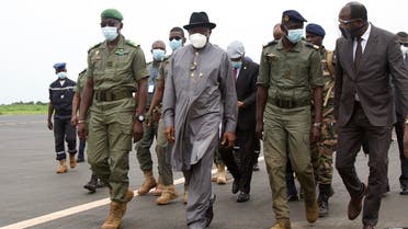 Former Nigerian President Goodluck Jonathan (2L) walks at the International Airport in Bamako upon his arrival on August 22, 2020 next to by Malick Diaw (L), the Vice President of the CNSP. (AFP)