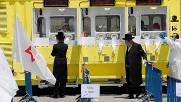 Ultra orthodox Jewish men stand by a testing station for coronavirus disease (COVID-19) in Jerusalem, April 21, 2020. (Reuters)