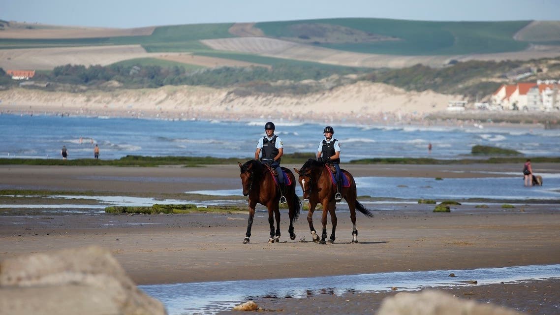 French gendarmes patrol the beach in Tardinghen, France, on August 20, 2020. (Reuters)